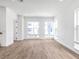 Bright living room featuring wood-look flooring and large windows for ample natural light at 2138 Whitney Marsh Aly, Orlando, FL 32804