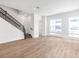 Open-concept living area with staircase, wood-look floors, and lots of natural light at 2138 Whitney Marsh Aly, Orlando, FL 32804