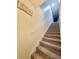 Carpeted staircase with simple handrail leading upstairs at 261 Carina Cir, Sanford, FL 32773