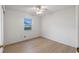 Well-lit bedroom with wood floors and a window at 27131 Racquet Cir, Leesburg, FL 34748