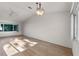 Sunlit living room, hardwood floors, and a ceiling fan at 27131 Racquet Cir, Leesburg, FL 34748