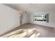 Spacious living room featuring light wood floors and a ceiling fan at 27131 Racquet Cir, Leesburg, FL 34748