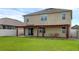 Spacious backyard features a covered patio, providing an ideal space for outdoor relaxation and entertaining at 205 Hamlet Rd, Davenport, FL 33837