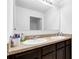 Bathroom featuring double sinks with a countertop, a large mirror, and dark hardwood floors at 205 Hamlet Rd, Davenport, FL 33837