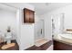 Clean bathroom featuring a glass shower, dark hardwood floors, and a wooden cabinet for storage at 205 Hamlet Rd, Davenport, FL 33837