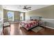 This bedroom features a ceiling fan, hardwood floors, and large windows providing natural light at 205 Hamlet Rd, Davenport, FL 33837