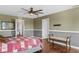 Bedroom featuring a ceiling fan, hardwood floors, a large bed, and two doorways leading to other rooms at 205 Hamlet Rd, Davenport, FL 33837