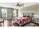 This bedroom features a ceiling fan, hardwood floors, and large windows providing natural light at 205 Hamlet Rd, Davenport, FL 33837