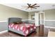 Bedroom featuring a ceiling fan, hardwood floors, a large bed and two doorways leading to other rooms at 205 Hamlet Rd, Davenport, FL 33837
