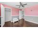 Bedroom featuring a closet, hardwood floors, a ceiling fan, and a doorway leading to another room at 205 Hamlet Rd, Davenport, FL 33837
