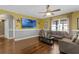 Living room featuring hardwood floors, comfortable seating, an entertainment center and a ceiling fan for added comfort at 205 Hamlet Rd, Davenport, FL 33837