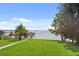 Lush green lawn leading to a private boat dock on a tranquil lake at 12428 Summerport Ln, Windermere, FL 34786