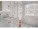 Bright bathroom with marble walk-in shower, vanity and neutral color palette at 12428 Summerport Ln, Windermere, FL 34786
