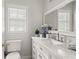 Elegant bathroom featuring marble vanity top, classic fixtures, and ample natural light at 12428 Summerport Ln, Windermere, FL 34786