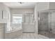 Elegant bathroom features double sinks, soaking tub and walk-in shower at 12428 Summerport Ln, Windermere, FL 34786
