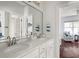 Bright bathroom features double sinks, granite counters and an open doorway at 12428 Summerport Ln, Windermere, FL 34786
