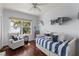 Comfortable bedroom features a day bed, water view and ceiling fan at 12428 Summerport Ln, Windermere, FL 34786