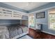 Charming bedroom features custom bunk beds, hardwood floors, and serene blue walls at 12428 Summerport Ln, Windermere, FL 34786