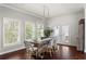 Bright dining room features wood floors, modern chandelier, and views to the outside at 12428 Summerport Ln, Windermere, FL 34786