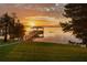 Scenic view of a boat dock on a peaceful lake at sunrise with vibrant colors at 12428 Summerport Ln, Windermere, FL 34786