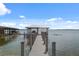 Well-maintained boat dock featuring a covered area and boat lift on a calm lake at 12428 Summerport Ln, Windermere, FL 34786