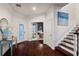 Bright foyer with hardwood floors, decorative table, and staircase leading to the second floor at 12428 Summerport Ln, Windermere, FL 34786