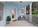 Cozy front porch featuring tile flooring, a small bench, and a decorative front door at 12428 Summerport Ln, Windermere, FL 34786