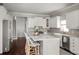 Gourmet kitchen boasts white cabinets, stainless appliances, and a large center island at 12428 Summerport Ln, Windermere, FL 34786