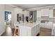 Gourmet kitchen boasts white cabinets, stainless appliances, and a large center island at 12428 Summerport Ln, Windermere, FL 34786