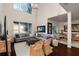 Bright living room with high ceilings, large windows, and cozy seating at 12428 Summerport Ln, Windermere, FL 34786