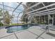 Private pool with a screened enclosure and expansive views of the waterfront at 12428 Summerport Ln, Windermere, FL 34786