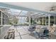 Stunning screened-in pool area with comfortable seating and waterfront views at 12428 Summerport Ln, Windermere, FL 34786