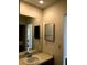 Neutral bathroom featuring a large mirror over the vanity and a mirrored medicine cabinet at 4559 Oak Arbor Cir, Orlando, FL 32808