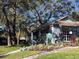 Charming clubhouse with ample windows, manicured landscaping and community signage at 4559 Oak Arbor Cir, Orlando, FL 32808