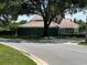 Charming single-story home boasts a well-maintained lawn, clay tile roof, and mature trees at 4559 Oak Arbor Cir, Orlando, FL 32808