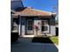 Charming one-story home with a tile roof, security door, neutral color, and well-kept landscaping at 4559 Oak Arbor Cir, Orlando, FL 32808