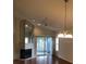 Bright living room with hardwood floors, fireplace, ceiling fan, and sliding glass doors at 4559 Oak Arbor Cir, Orlando, FL 32808