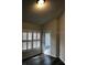 Bright living space with sleek flooring, shuttered windows and access to the outdoors at 4559 Oak Arbor Cir, Orlando, FL 32808