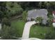 Expansive aerial view showcasing the home's large lot, mature trees, and meticulously manicured landscaping at 4901 Shoreline Cir, Sanford, FL 32771