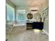 Elegant bathroom featuring a tub, tiled shower, double sinks, and natural light at 4901 Shoreline Cir, Sanford, FL 32771