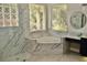 Luxurious bathroom with marble accents, soaking tub, and stylish fixtures at 4901 Shoreline Cir, Sanford, FL 32771