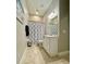 Neutral bathroom with decorative shower curtain and white vanity provides ample storage at 4901 Shoreline Cir, Sanford, FL 32771