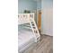 Cozy bedroom with a white bunk bed featuring a trundle bed and white linens at 4901 Shoreline Cir, Sanford, FL 32771