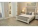 Inviting bedroom with modern flooring, ensuite, and ample natural light at 4901 Shoreline Cir, Sanford, FL 32771