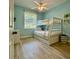 Charming bunk bedroom features a ceiling fan, soft colors, and wood-look floors at 4901 Shoreline Cir, Sanford, FL 32771