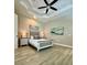 Comfortable bedroom with trey ceiling, wood floors, and stylish decor at 4901 Shoreline Cir, Sanford, FL 32771