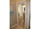 Bright bedroom featuring wood floors, a ceiling fan, and a doorway that leads to the bathroom at 4901 Shoreline Cir, Sanford, FL 32771