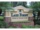 Lake Forest Swim & Tennis Club community sign surrounded by lush landscaping and colorful flowers, creating a welcoming entrance at 4901 Shoreline Cir, Sanford, FL 32771