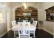 Elegant dining room with a rustic wood accent wall and stylish decor, perfect for gatherings at 4901 Shoreline Cir, Sanford, FL 32771