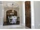 Charming dining room with a decorative wood accent wall, elegant lighting, and a comfortable seating arrangement at 4901 Shoreline Cir, Sanford, FL 32771